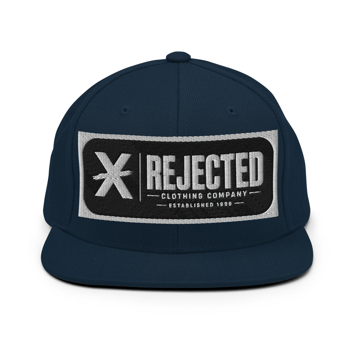 All-black snapback with an embroidered Rejected Clothing Company Established 1999 patch and a green undervisor