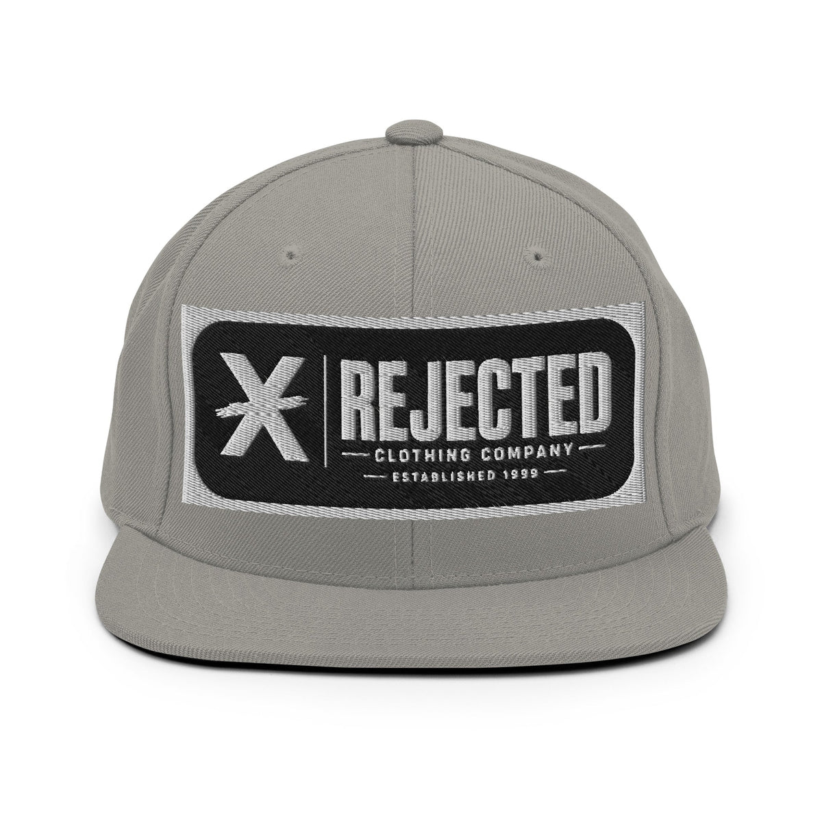 All-black snapback with an embroidered Rejected Clothing Company Established 1999 patch and a green undervisor
