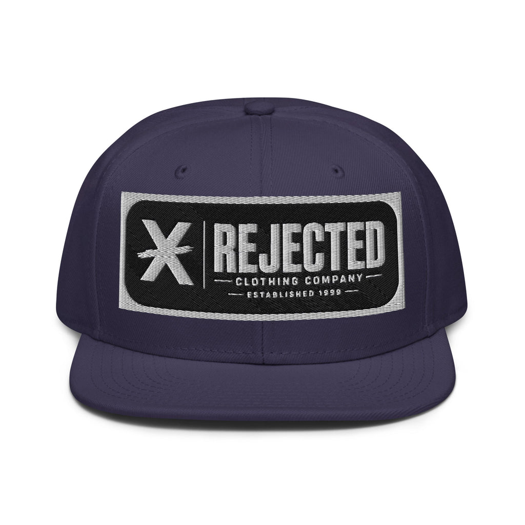 Black snapback with a teal brim and an embroidered Rejected Clothing Company Established 1999 patch