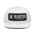 Black snapback with a teal brim and an embroidered Rejected Clothing Company Established 1999 patch
