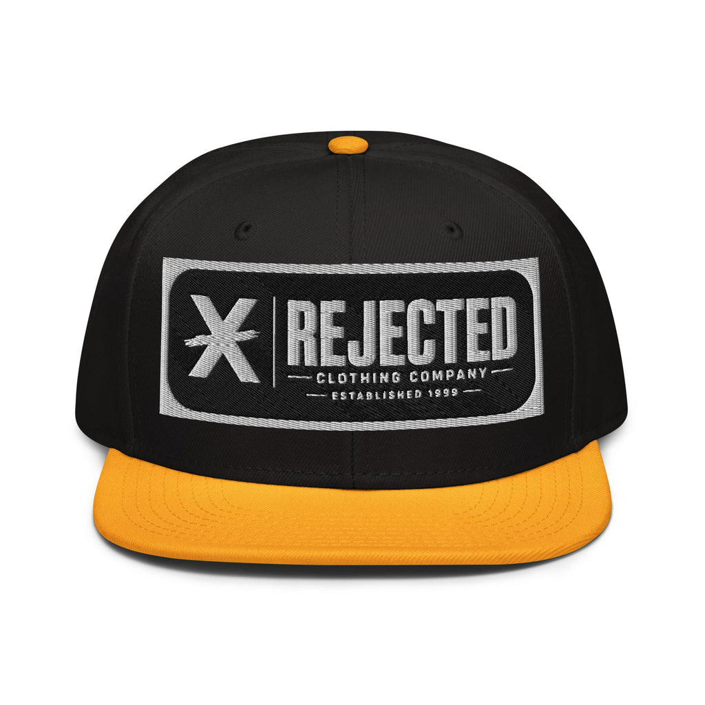 Black snapback with a teal brim and an embroidered Rejected Clothing Company Established 1999 patch