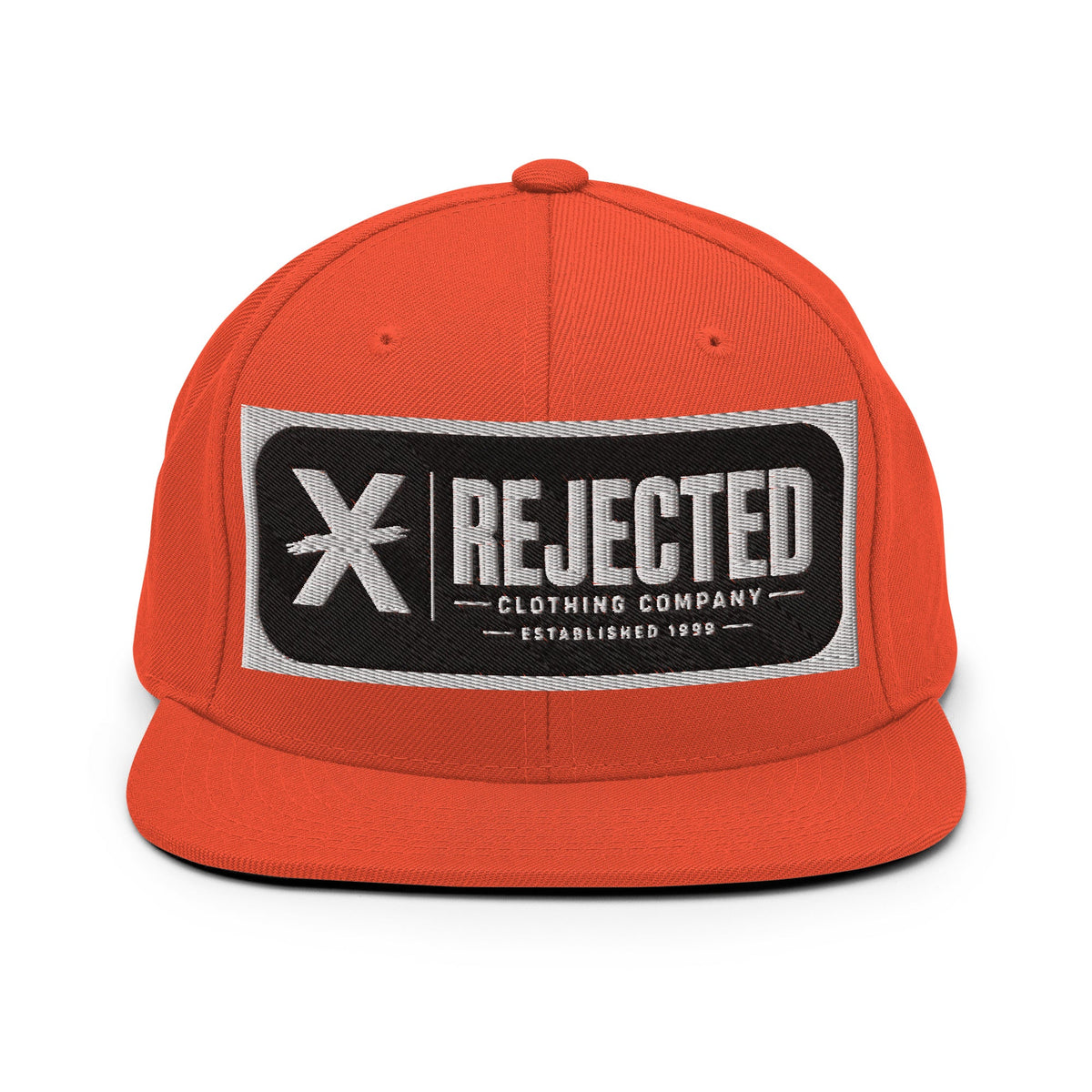 All-black snapback with an embroidered Rejected Clothing Company Established 1999 patch and a green undervisor