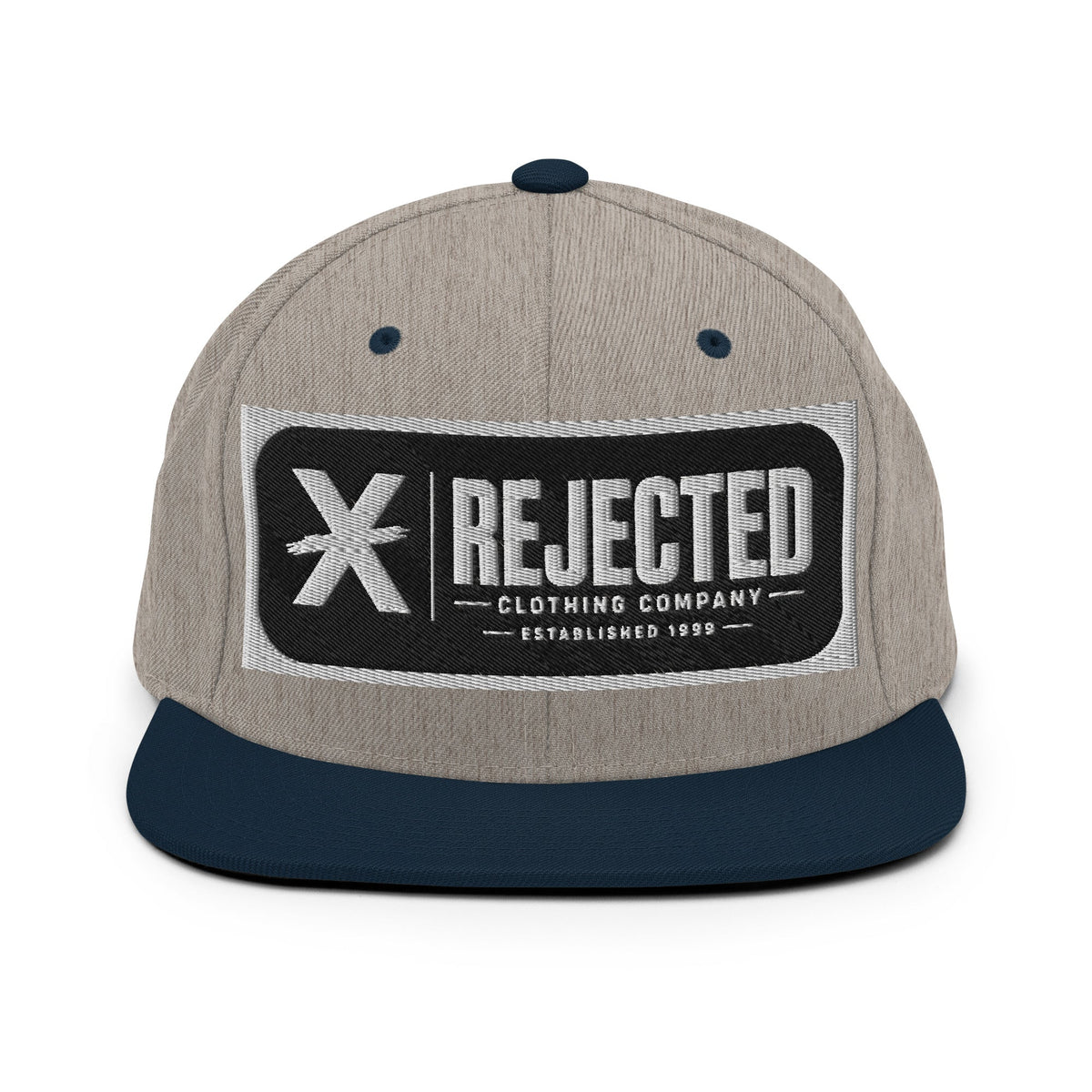 All-black snapback with an embroidered Rejected Clothing Company Established 1999 patch and a green undervisor