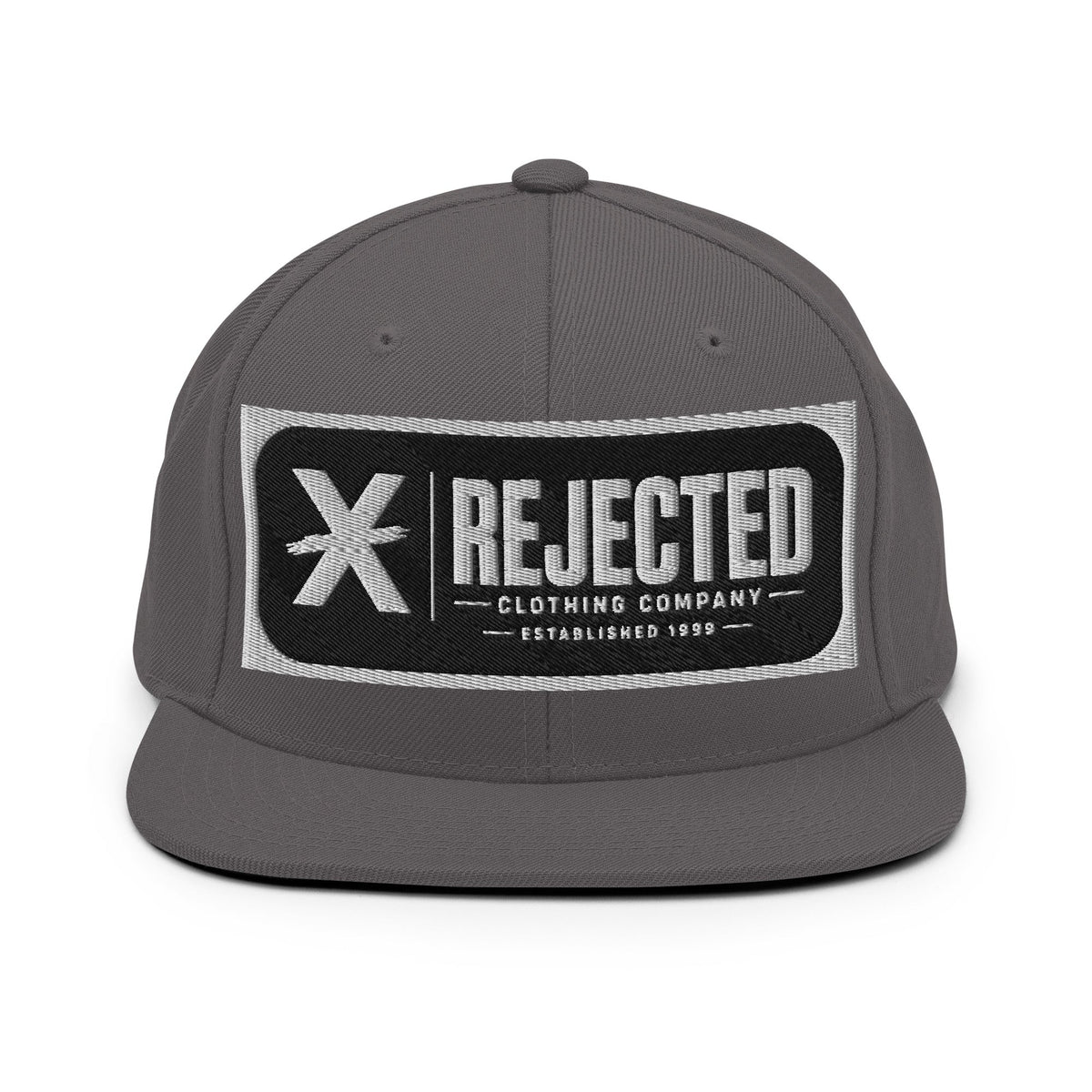 All-black snapback with an embroidered Rejected Clothing Company Established 1999 patch and a green undervisor