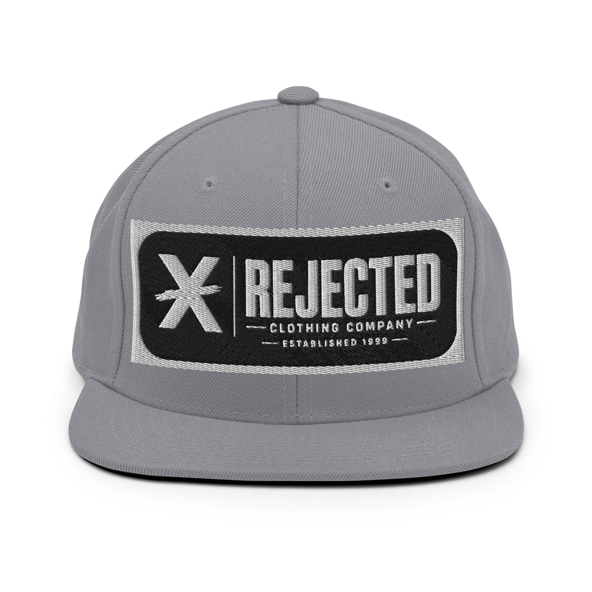 All-black snapback with an embroidered Rejected Clothing Company Established 1999 patch and a green undervisor