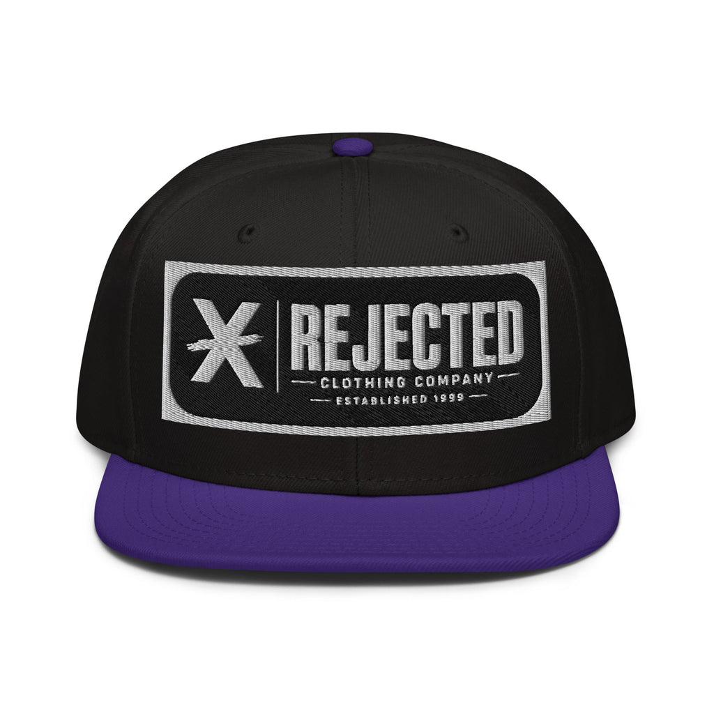 Black snapback with a teal brim and an embroidered Rejected Clothing Company Established 1999 patch