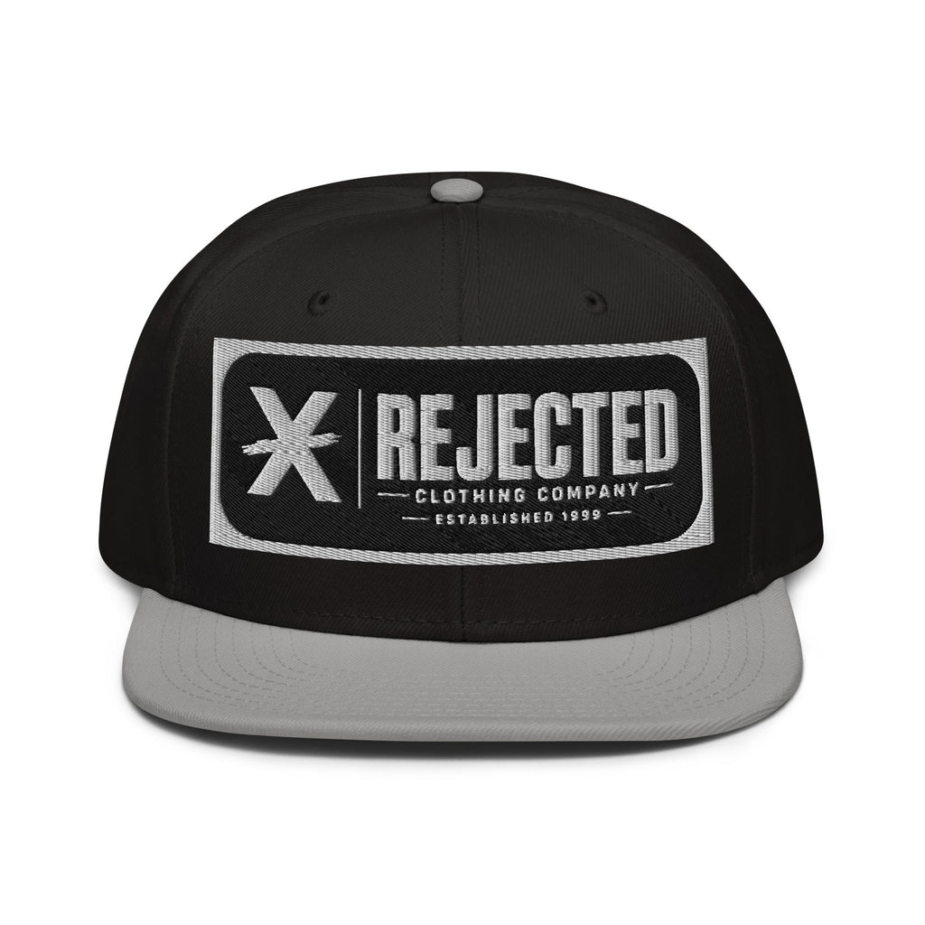 Black snapback with a teal brim and an embroidered Rejected Clothing Company Established 1999 patch