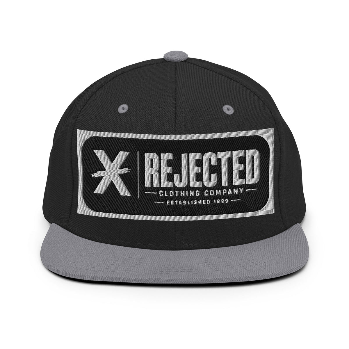 All-black snapback with an embroidered Rejected Clothing Company Established 1999 patch and a green undervisor
