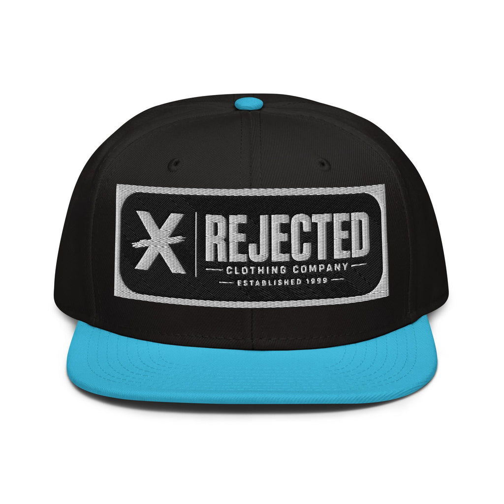 Black snapback with a teal brim and an embroidered Rejected Clothing Company Established 1999 patch