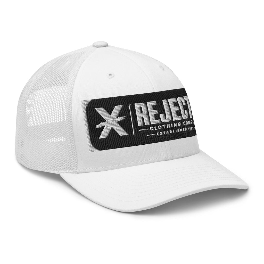 White trucker cap with an embroidered Rejected Clothing Company Established 1999 patch and X mark