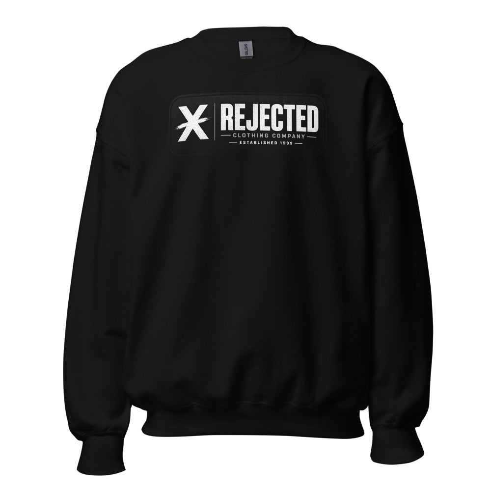 Black crewneck sweatshirt with the Rejected Clothing Company Established 1999 brush X label on the chest